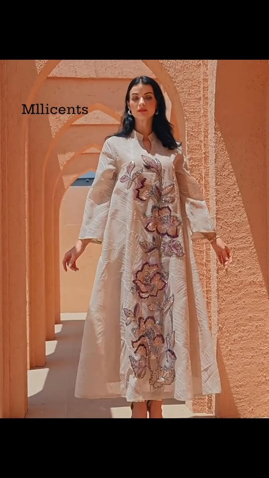 Woman wearing a floral embroidered Mllicents gown